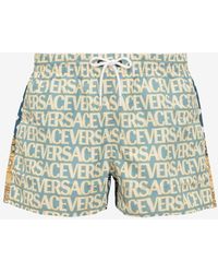Versace - All-Over Logo Polka Dot Swim Shorts - Lyst