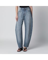 Alaïa - Low-Rise Curved-Leg Raw Denim Jeans - Lyst