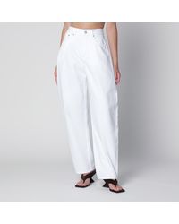 Alaïa - High-Waisted Curved-Leg Denim Jeans - Lyst