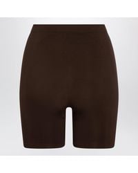 Skims - Cocoa Seamless Sculpt Mid-Thigh Shorts - Lyst