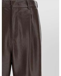 ANDAMANE - Leather-Effect Pleated Flared Trousers - Lyst