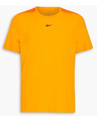 Reebok Bedrucktes t-shirt aus stretch-jersey mit mesh-einsatz - Orange