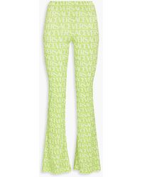Versace - Printed Stretch-Velvet Flared Pants - Lyst