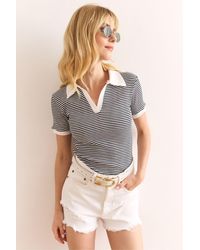 Olalook - Gestreifte Schwarze Bluse Mit Polokragen Und Farbigen Details Aus Dehnbarer Baumwolle Für Damen - Lyst