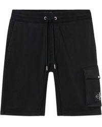 Calvin Klein - Monogram insignia jogger pantalones cortos negros - Lyst