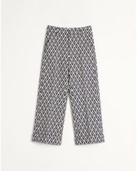 Valentino - Wool Trousers With Cuffs With Toute La V Jacquard Pattern - Lyst