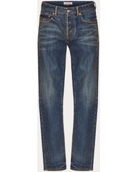 Valentino - Denim Trousers With Metallic V Detail - Lyst
