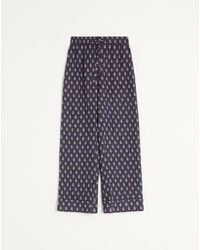 Valentino - Lightweight Cuffed Linen Trousers With Voyage Imaginaire Print - Lyst
