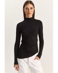Bianco Lucci - Fitted Turtleneck Long Sleeve Blouse With Ruffle Detail - Lyst