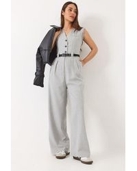 Bianco Lucci - V-Hals Wijde Pijpen Jumpsuit Met Strikdetail - Lyst