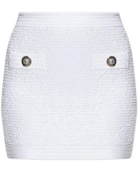 Balmain - Short Tweed Skirt With Appliqués - Lyst
