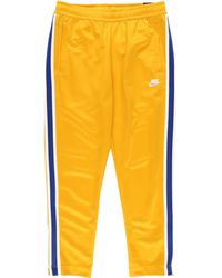 nike track pants yellow