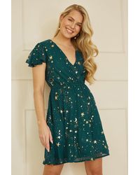 Yumi' - Foil Star Print Wrap Skater Dress - Lyst