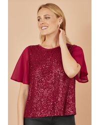 Yumi' - Sequin Top With Sheer Sleeves And Cut Out Back - Lyst