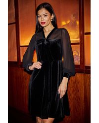 Yumi' - Velvet Pussy Bow Sheer Sleeves Skater Dress - Lyst