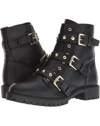 guess black boots gold buckle