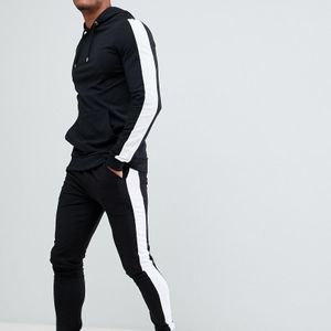 Chándal negro con sudadera con capucha ajustada y joggers muy ajustados con rayas laterales en blanco ASOS de hombre