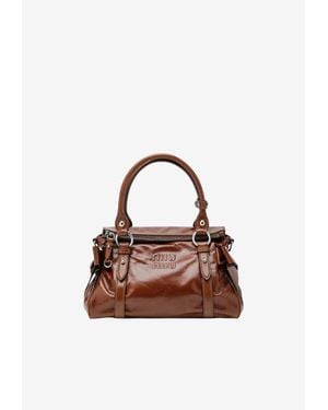 Miu Miu Embossed Logo Shiny Leather Top Handle Bag - Brown
