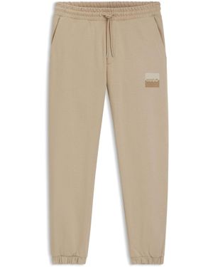 HUGO Dusplitan Jogginghose aus Baumwoll-Terry mit Split-Logo Beige S - Natur