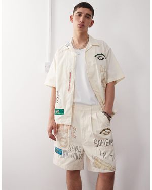 Aape By A Bathing Ape Aape By A Bathing Ape Multi Logo University Shorts - Natural