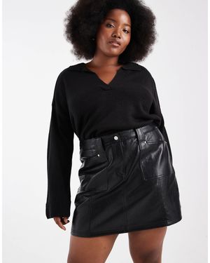 Renee Studio Exclusivité - renée studio plus - mini-jupe en imitation cuir avec poche devant et coutures apparentes - Noir