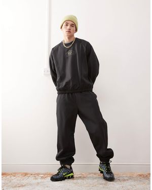 Weekday Co-ord Oversized sweatpants With Fantazy Fussball Graphic Print And Contrast Seams - Black