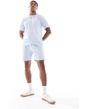 Another Influence Pantalones Cortos Azules Holgados Con Lavado Ácido Y Detalle De Costura De