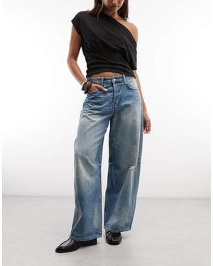 Weekday Jean large baggy à taille basse avec détails usés, délavage délavé - Bleu