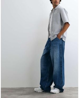 ASOS Jeans A Gamba Ampia Lavaggio Medio Con Pieghe - Blu