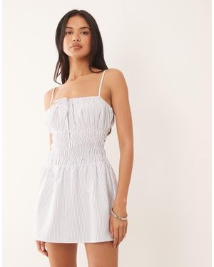The Frolic Exclusive Poplin Look Shirred Tie Front Cami Flippy Hem Mini Dress - White