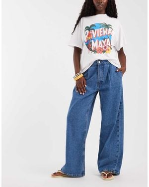 ASOS Jeans A Cavallo Basso Lavaggio Medio Con Pieghe Sul Davanti - Blu