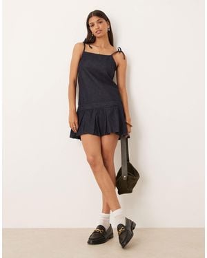 embellished cami mini dress with flippy hem in black Moon River Spaghetti Cutout Tiered Midi Dress – Elements Berkeley main image 1