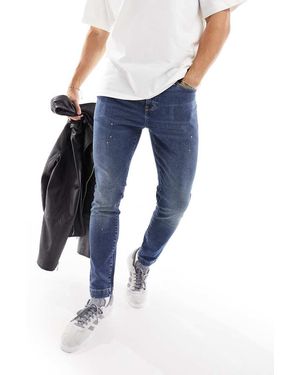 ASOS Vaqueros Azules De Corte Pitillo Con Salpicaduras De Pintura Y Lavado Medio De