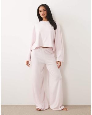 ASOS Pyjamabroek Van Zachte Jersey Met Wijde Pijpen En Bloempje Aan De Rand - Roze