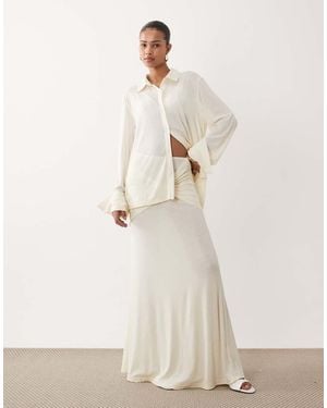 SNDY'S Soft Fine Knit Semi Sheer Ruched Twist Front Detail Maxi Skirt - Natural