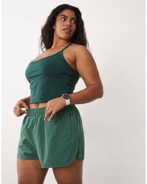 4505 Curve Icon Woven Running Shorts With Zip Pockets - Green
