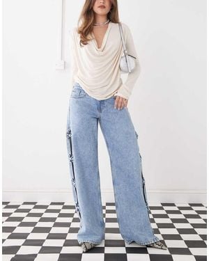 Monki Imoo Low Waist Wide Leg Jeans With Cut Out Bow Details - Blue
