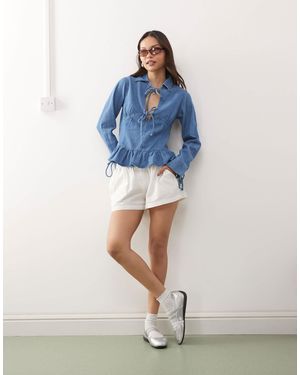 Reclaimed (vintage) Long Sleeve Denim Tie Front Top With Peplum Hem - Blue