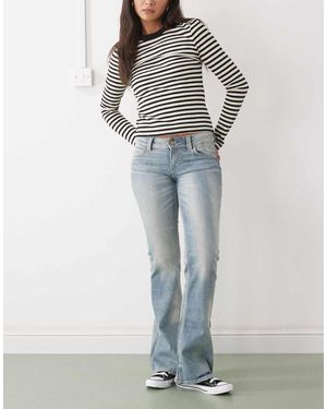 Cheap Monday Vaqueros Azules Elásticos De Corte Bootcut Y Talle Bajo Con Lavado Nuboso Booty Bei De