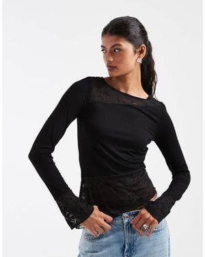 Pieces Top asymétrique en dentelle à manches longues avec détails aux poignets en - Noir