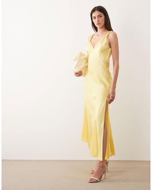 Never Fully Dressed Sofia - robe longue en satin coupé en biais à bretelles nouées - citron - Neutre
