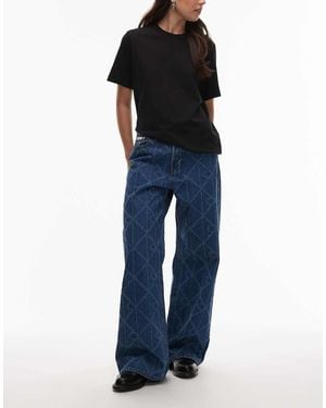 Calvin Klein Laser Cut Repeat Logo Low Rise baggy Jeans - Blue