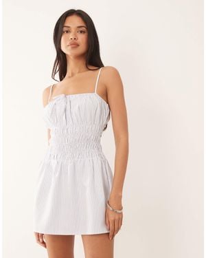 The Frolic Exclusive Poplin Look Shirred Tie Front Cami Flippy Hem Mini Dress - White