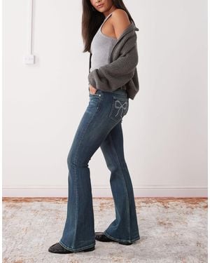 Monki Katsumi Low Waist Flare Jeans With Bow Embellishment-blue - White