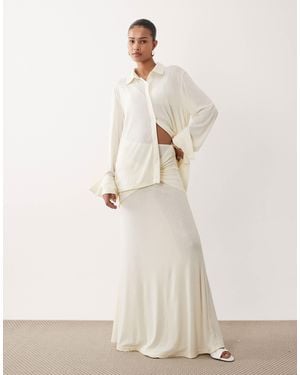 SNDY'S Soft Fine Knit Semi Sheer Ruched Twist Front Detail Maxi Skirt - Natural