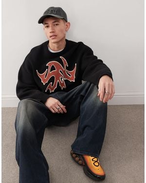 Weekday Cypher - pull oversize avec motif graphique rouge en jacquard - Noir