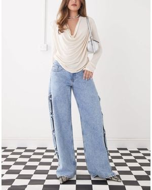 Monki Imoo Low Waist Wide Leg Jeans With Cut Out Bow Details - Blue