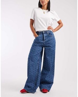 Tommy Hilfiger Charlie Loose Jeans With All Over Logo Print - Blue