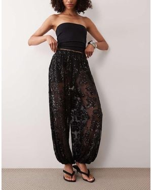 TFNC London Floral Sequin Sheer Elasticated Waist Balloon Leg Trousers - Black