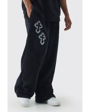 BoohooMAN Wide Leg Embroidered Gothic Cross Teddy Borg Joggers - Black